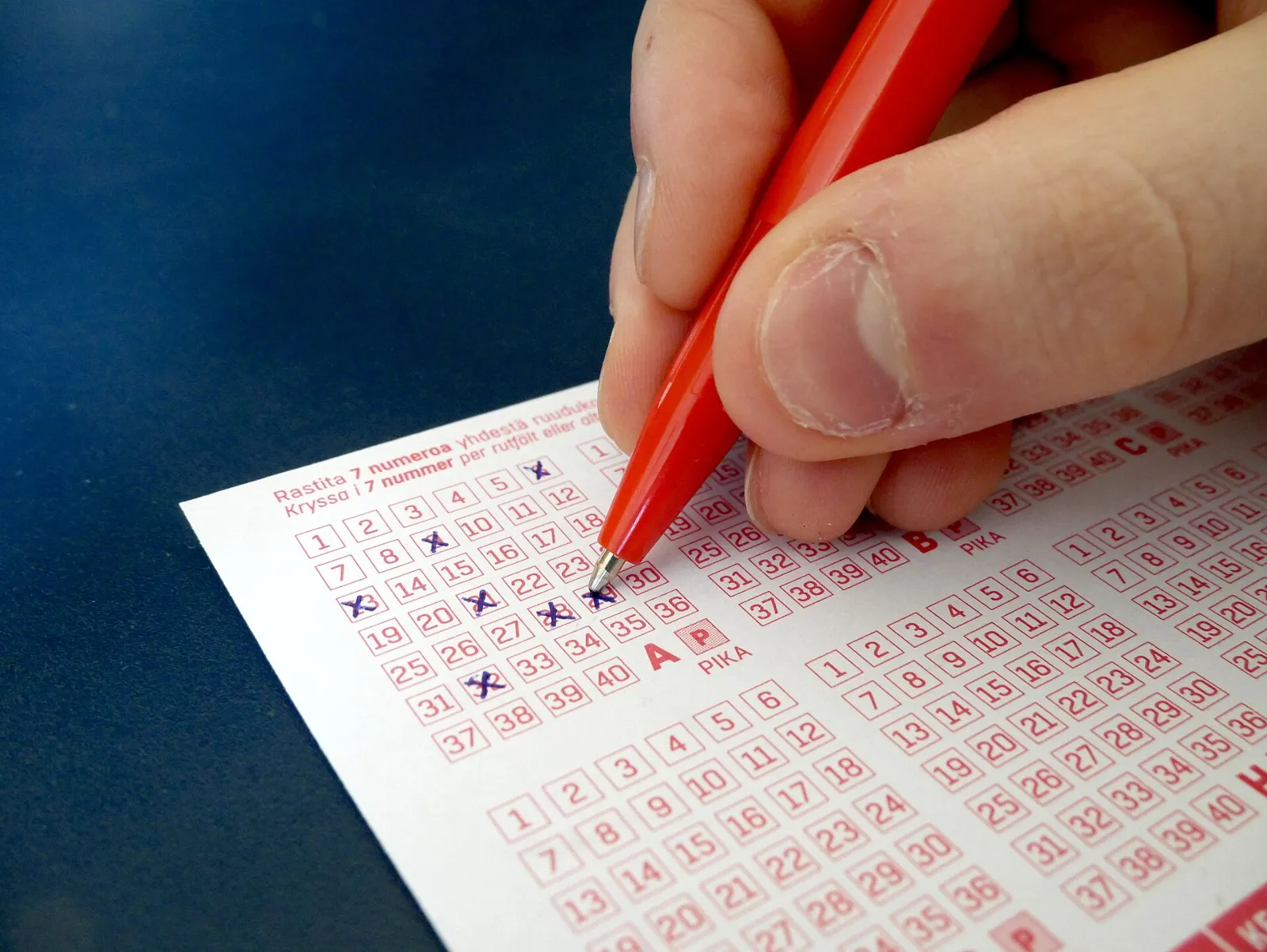 Filling lottery ticket.